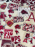 Load image into Gallery viewer, Collection of Arkansas Razorbacks-themed stickers with logos and text on a beige background. Arkansas razorback stickers, razorback stickers, arkansas stickers near me, razorback store Fayetteville ar
