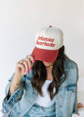 Load image into Gallery viewer, Person wearing a red and white 'Arkansas Razorbacks' cap with a denim jacket. Arkansas razorback hat, razorback trucker hat, Arkansas hat, Arkansas trucker hat, Fayetteville ar boutique, Fayetteville boutique razorback clothing, razorback store