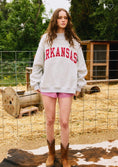 Load image into Gallery viewer, Person wearing an 'Arkansas' sweatshirt on a farm red Arkansas reversible sweatshirt, red Arkansas reversible mock neck, Arkansas reversible sweatshirt, Arkansas reversible mock neck, AR reversible sweatshirt, AR reversible mock neck, red AR reversible sweatshirt, red AR reversible mock neck, store near me, ARkansas reversible mock neck near me, Arkansas reversible sweatshirt near me