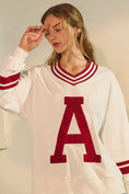 Load image into Gallery viewer, Person wearing a white sweater with a red 'A' on a plain background, Arkansas varsity style sweatshirt, sweatshirt with an arkansas “A”, raorback sweatshirt, white Arkansas sweatshirt, shopping in Fayetteville, ar, razorback store near me