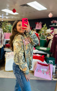 Load image into Gallery viewer, Woman wearing a camouflage Arkansas sweatshirt in Whimsy Whoo Boutique in their Arkansas Razorback Store. Camo Arkansas sweatshirt for women, camo Arkansas shirt, camo arkansas razorback shirt, camo arkansas razorback sweatshirt, camo arkansas crewneck, arkansas razorback store, women Arkansas sweatshirts