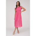 Load image into Gallery viewer, A woman wearing a pink, short-sleeved, smocked bodice midi dress with a round neckline and a tiered skirt.