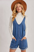 Load image into Gallery viewer, Woman wearing a denim romper with a white turtleneck and brown hat on a light gray background, denim romper shorts, denim romper near me, Fayetteville ar boutique, Arkansas boutiques