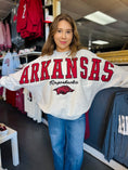Load image into Gallery viewer, Woman wearing an Arkansas Razorbacks sweatshirt in a Fayetteville ar razorback store, arkansas sweatshirts, Arkansas razorback shirt, razorback sweatshirts for women, arkansas razorback sweatshirt nearby, arkansas razorback store, store near me, Fayetteville ar stores, arkansas razorback store