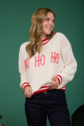 Load image into Gallery viewer, Woman wearing a white sweater with 'Ho Ho Ho' text in a Fayetteville, ar clothing store. Christmas sweaters, women’s Christmas sweater, christmas sweater women
