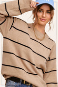 Load image into Gallery viewer, Woman wearing a beige sweater with black stripes, blue cap, and gold necklace. Striped sweater, fall sweaters, clothing stores Fayetteville ar, whimsy whoo