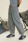 Load image into Gallery viewer, Person wearing gray checkered pants and blue Adidas sneakers in a minimal indoor setting. navy parachute pants, parachute pants 80s, parachute pants women, parachute pants h&m, parachute pants 90s, parachute pants near me, parachute pants my hammer, barrel pants, barrel leg pants, barrel jeans barrel pants trousers, barrel jeans women, barrel pants anthropology