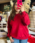 Load image into Gallery viewer, Women wearing a red razorback sweatshirt with small embroidered hogs, taking a selfie in a Fayetteville, ar store. Arkansas Razorback sweatshirt for women, arkansas razorback store Fayetteville, ar, Arkansas boutique, Whimsy Boutique