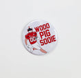 Load image into Gallery viewer, Button badge with football player graphic and 'Wood Pig Sooie' text on a white background, arkansas razorback jewelry and accessories, boutiques open now, razorback store Fayetteville ar