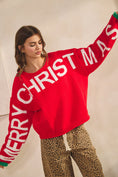 Load image into Gallery viewer, Woman wearing a red sweater with 'Merry Christmas' text against a plain background, christmas sweater, women’s christmas sweaters, christmas sweater women
