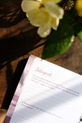 Load image into Gallery viewer, Notebook with 'Interpret' page on a wooden surface with flowers