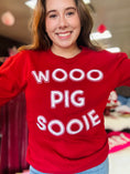 Load image into Gallery viewer, A full portrait shot of the Wooo Pig Sooie red sweatshirt, the perfect spirit piece for repping the Hogs at Baum-Walker Stadium or the Fayetteville Square.