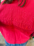 Load image into Gallery viewer, Close-up of the high-quality tonal embroidery on the back of the Charming Stitch jacket featuring "Arkansas Razorbacks" and "Wooo Pig Sooie" script for premium gameday apparel.