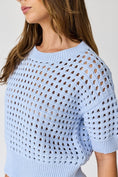 Load image into Gallery viewer, A close-up detail of the intricate open-weave crochet knit and ribbed crew neckline on the Sky Blue Oh Hey Crochet! top