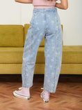 Load image into Gallery viewer, Back view of high-waisted floral barrel leg jeans at Whimsy, a boutique in Fayetteville.