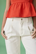 Load image into Gallery viewer, A close-up of the mid-rise waistband and pleated front detail on the off-white Executive Edge Barrel Pants.