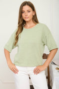 Load image into Gallery viewer, A three-quarter view of our sage green boxy knit sweater with drop shoulders. Perfect for transitional weather, available now at Whimsy Boutique, a premier Arkansas boutique.