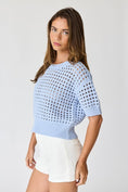 Load image into Gallery viewer, Side profile of the Sky Blue Oh Hey Crochet! top, showing the relaxed short sleeves and the perfect cropped length for high-waisted barrel jeans.