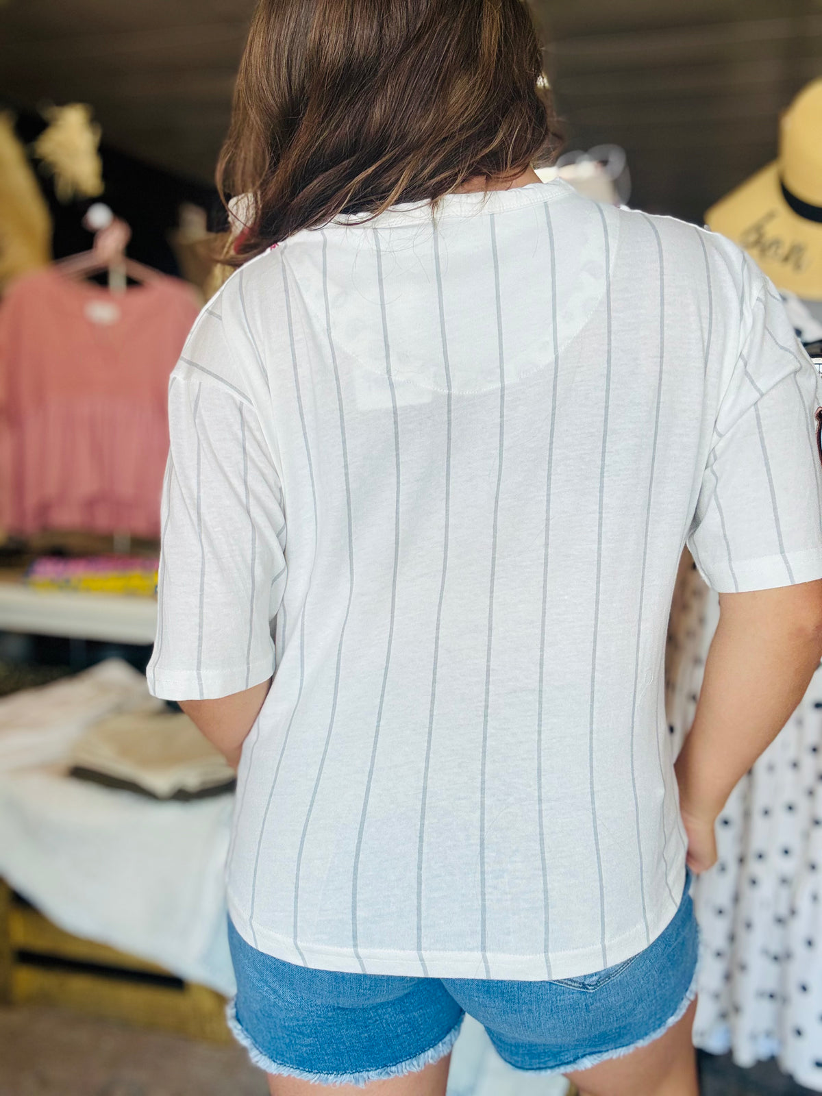 back view of women’s Arkansas razorback pinstripe baseball jersey from whimsy Whoo boutique store and razorback shop
