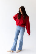 Load image into Gallery viewer, Woman wearing a red  arkansas razorback sweater and light blue jeans on a white in a Fayetteville, ar store Women wearing a red razorback sweatshirt with small embroidered hogs, taking a selfie in a Fayetteville, ar store. Arkansas Razorback sweatshirt for women, arkansas razorback store Fayetteville, ar, Arkansas boutique, Whimsy Boutique
