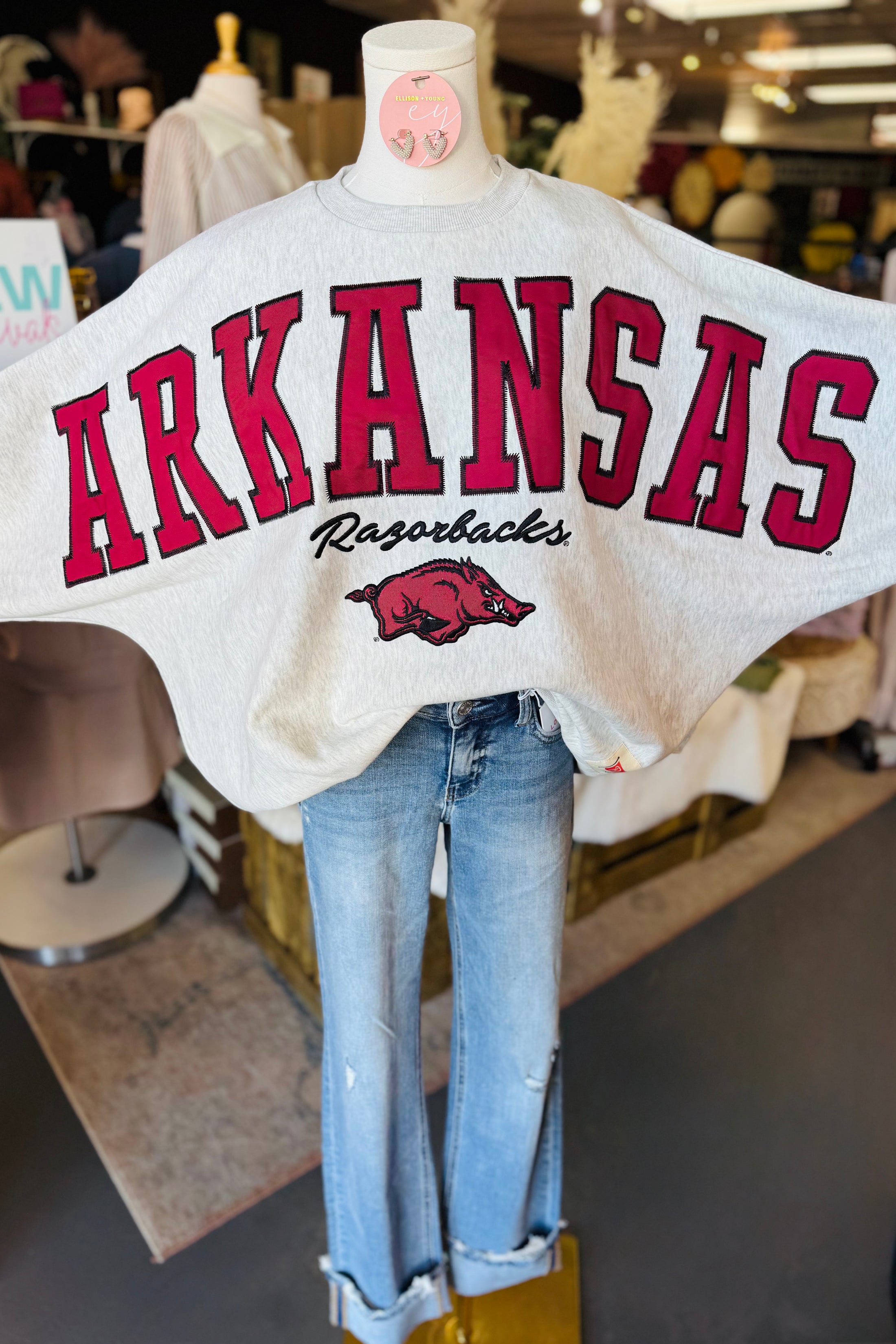 Mannequin wearing a 'Arkansas Razorbacks' sweatshirt in a Fayetteville ar razorback shop, white razorback oversized sweatshirt, fayetteville arkansas razorback stores, arkansas razorback store