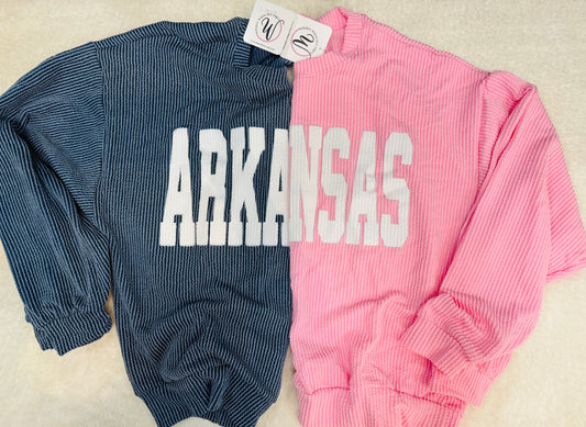Two ribbed long-sleeve shirts, one navy and one pink, with 'ARKANSAS' printed on them. Razorback shirts for women, arkansas boutique, Razorback Store, Arkansas Razorback Store, Arkansas Razorback Shirts women