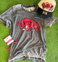 Load image into Gallery viewer, Gray t-shirt with red Razorback logo on a green surface, accompanied by a cap and tag, slobbering hog tshirt, whimsy whoo boutique razorback store, razorback t-shirts in Arkansas, razorbacks team shop
