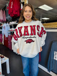 Load image into Gallery viewer, Woman wearing an Arkansas Razorbacks sweatshirt in a Fayetteville ar store near me near the Fayetteville mall, razorback store near me, arkansas sweatshirt for women, razorback sweatshirt, shopping near me, arkansas razorback store, store near me, Fayetteville ar stores, arkansas razorback store

