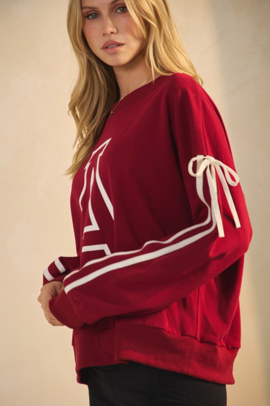 Red sweatshirt with white drawstrings worn by a person on a beige background, arkansas sweatshirt, A sweatshirt, arkansas sweatshirt women, arkansas sweatshirt near me, arkansas sweatshirt nearby, embroidered arkansas sweatshirt, university of arkansas crewneck