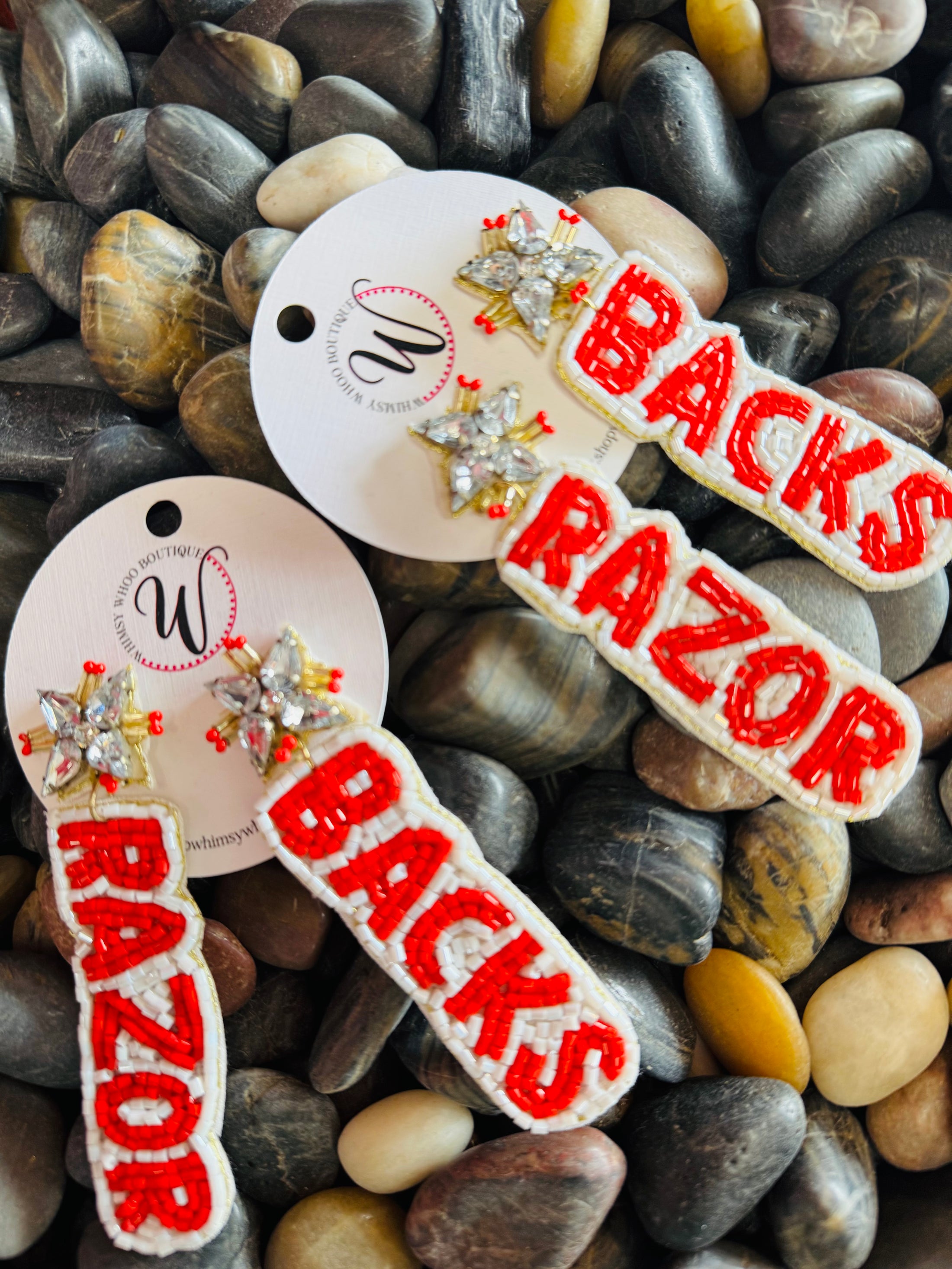 Unique beaded Razorback earrings, meticulously crafted in the official school colors (red and white) for maximum visibility on game day. The perfect, distinctive accessory available at the premier Arkansas Razorback store in Fayetteville.