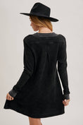Load image into Gallery viewer, Person wearing a black dress and hat from behind on a light gray background, thermal knit dresses, waffle knit dress with sleeves, boutiques Fayetteville ar, clothing stores near me
