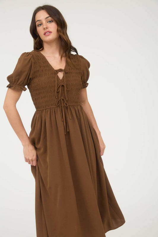 Woman wearing a brown dress with puff sleeves on a white background, blu pepper clothing, blu pepper dress, brown dress, brown maxi dress, brown midi dress, autumn dresses for women, fall dresses for women