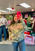Load image into Gallery viewer, Woman wearing a camouflage Arkansas sweatshirt in Whimsy Whoo Boutique in their Arkansas Razorback Store.  Camo Arkansas sweatshirt for women, camo Arkansas shirt, camo arkansas razorback shirt, camo arkansas razorback sweatshirt, camo arkansas crewneck, arkansas razorback store, women Arkansas sweatshirts 

