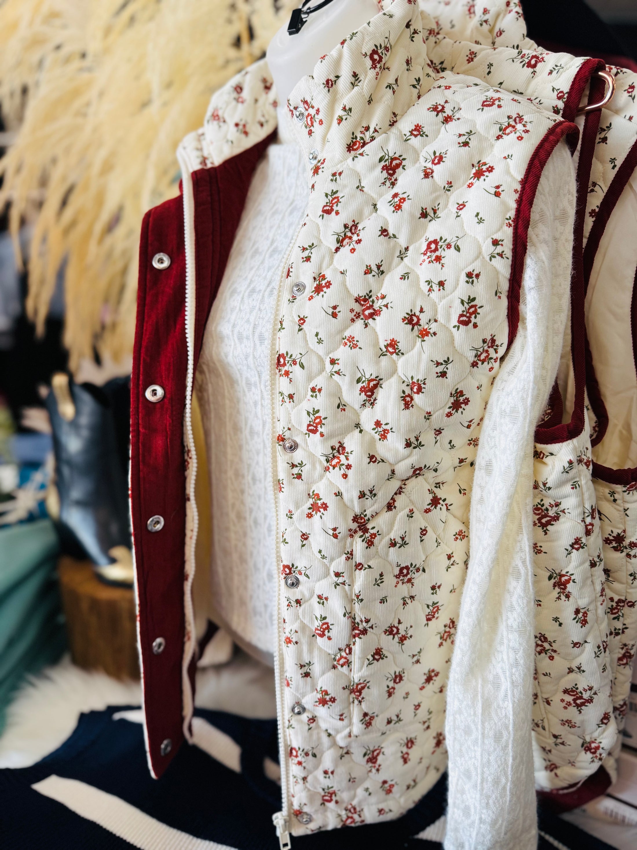 Woman wearing a floral vest for fall in a stores in fayetteville, ar fall floral vest, floral vests for women, floral vest top, floral vest outfit, shopping near me the Fayetteville Mall