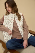 Load image into Gallery viewer, Woman wearing a floral vest over a brown sweater and blue jeans, sitting on a couch. Floral vest, floral vest zara, floral vest top, floral vest puffer, floral vest women’s, vintage floral vest
