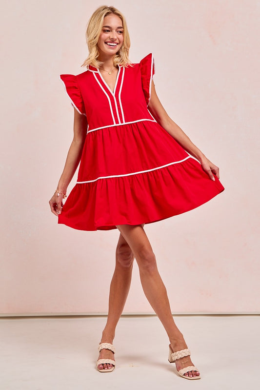 Woman wearing a red dress with white trim against a plain background, gameday dresses red, gameday dresses near me, gameday dress red, gameday dress maroon, gameday dress for Arkansas, razorback store, shopping Fayetteville, boutique in fayetteville ar