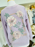 Load image into Gallery viewer, Lavender sweater with floral designs on a mannequin in a store setting
