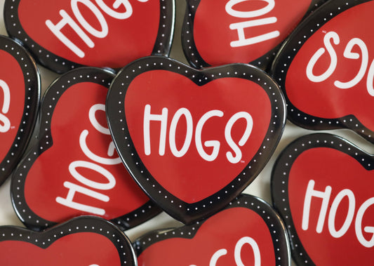 Heart-shaped red razorback gameday pins with 'HOGS' text on a white background