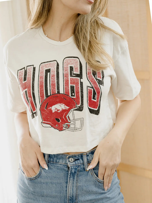 Women’s officially licensed Arkansas Razorback corp tee featuring a vintage HOGS football helmet graphic, perfect for game day and football season.