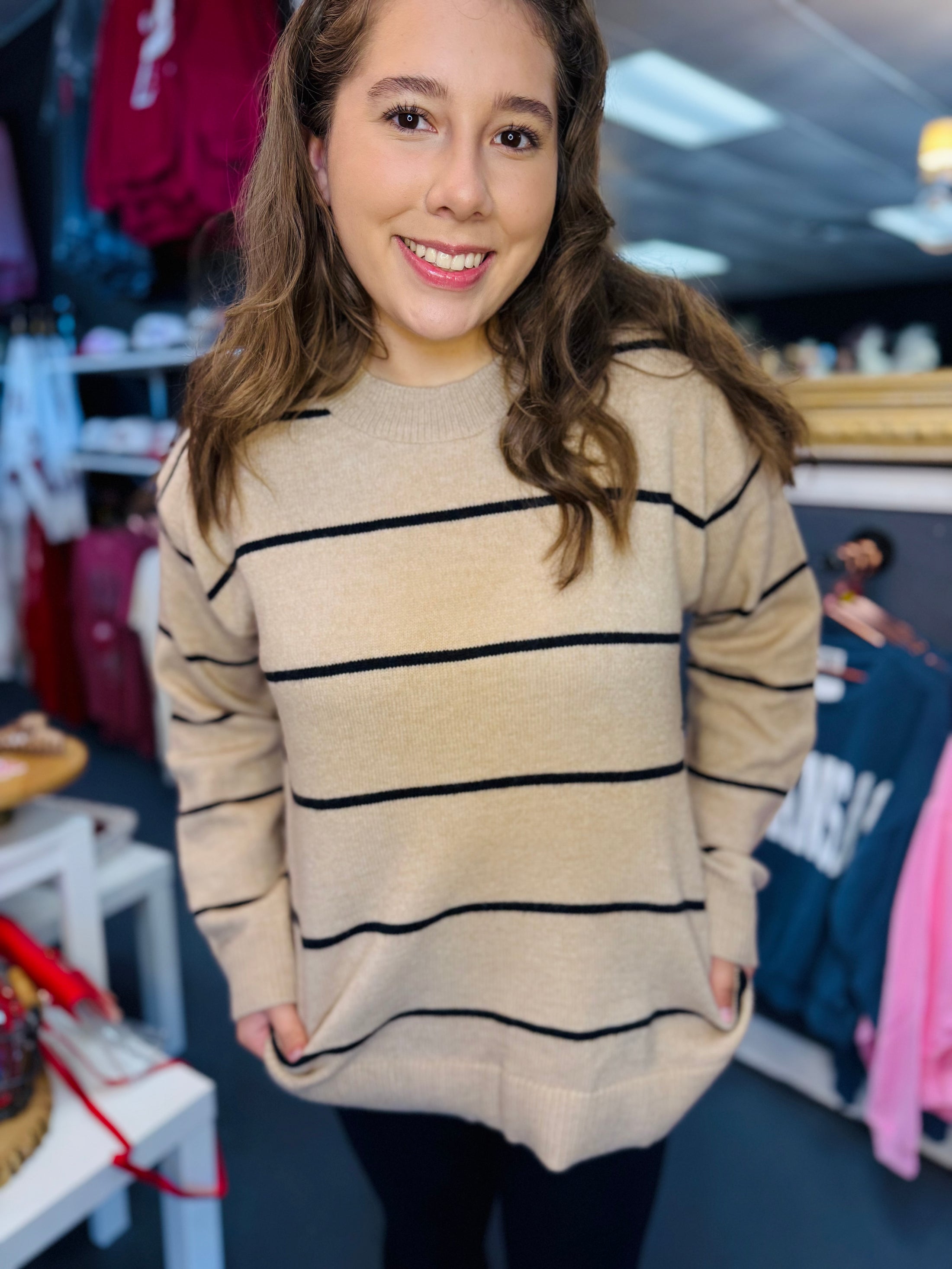 Woman wearing a beige sweater with black stripes in Whimsy Whoo clothing store Fayetteville ar, la miel sweater, sweaters for women near me