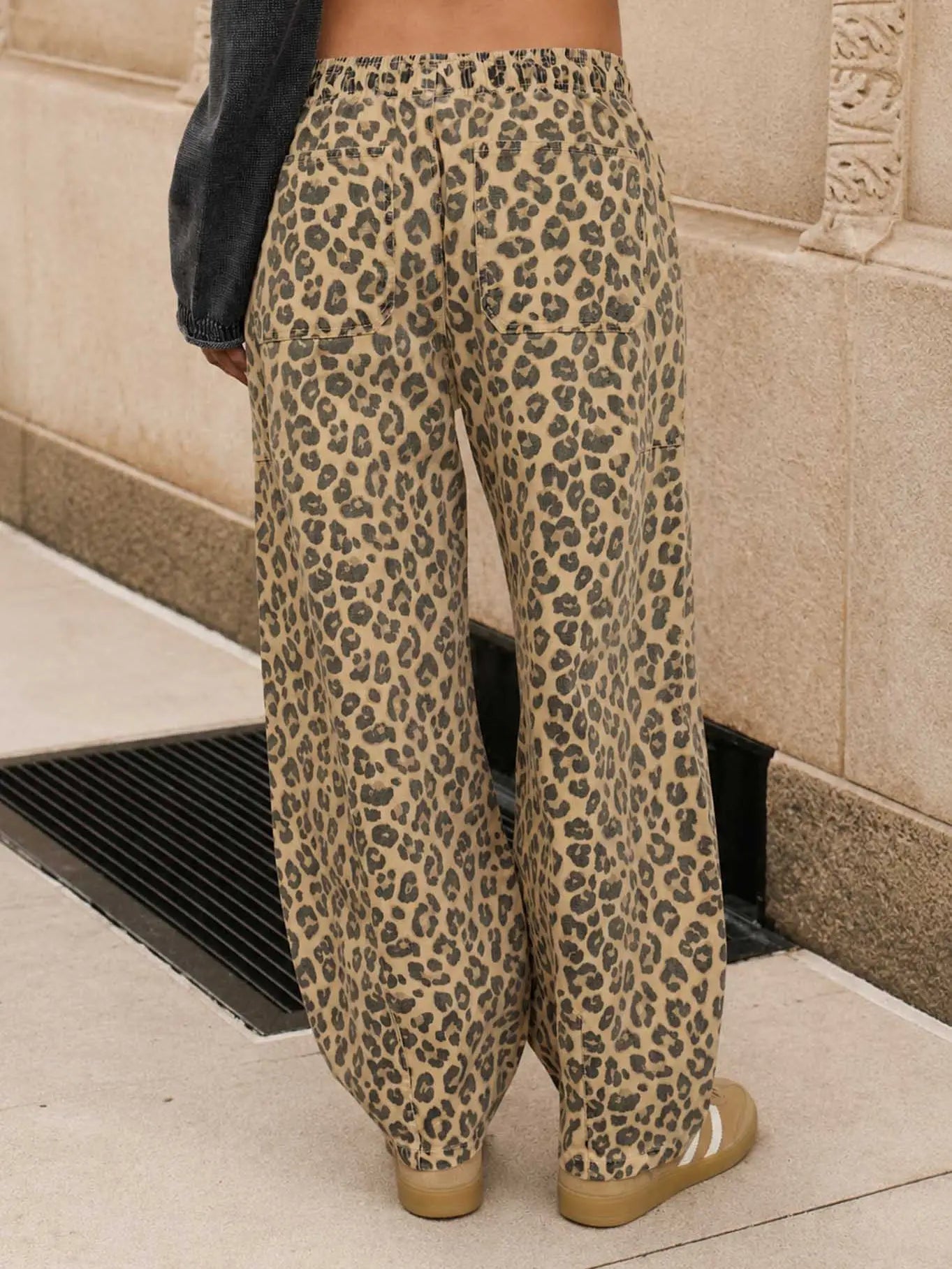 Wide-leg leopard print pants in beige and brown, shown on a woman from a Fayetteville boutique: Whimsy Whoo boutique store.