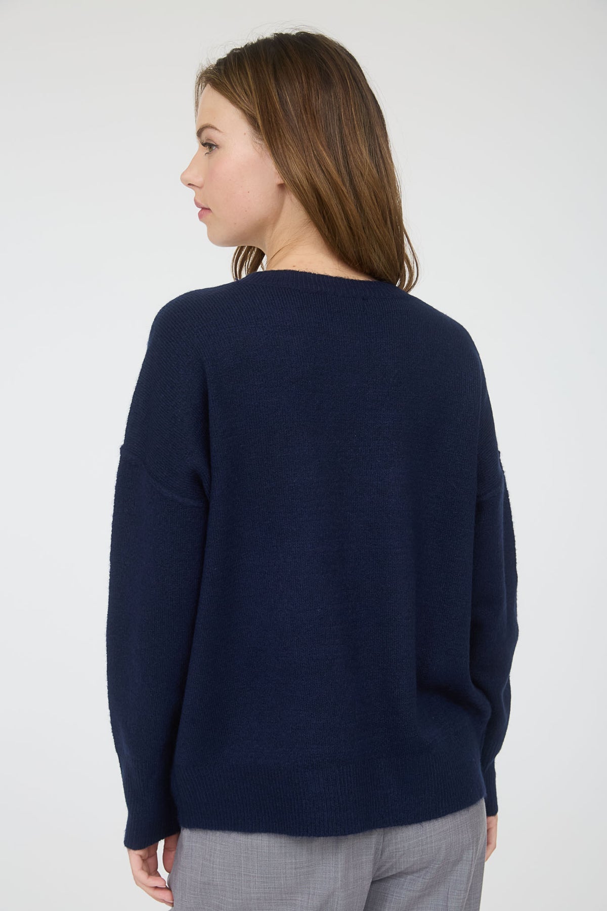 Woman wearing a navy blue sweater against a white background, navy blue sweater, soft navy sweater, navy blue top, blu pepper top, blu pepper sweater, shopping near me, Fayetteville ar boutique store