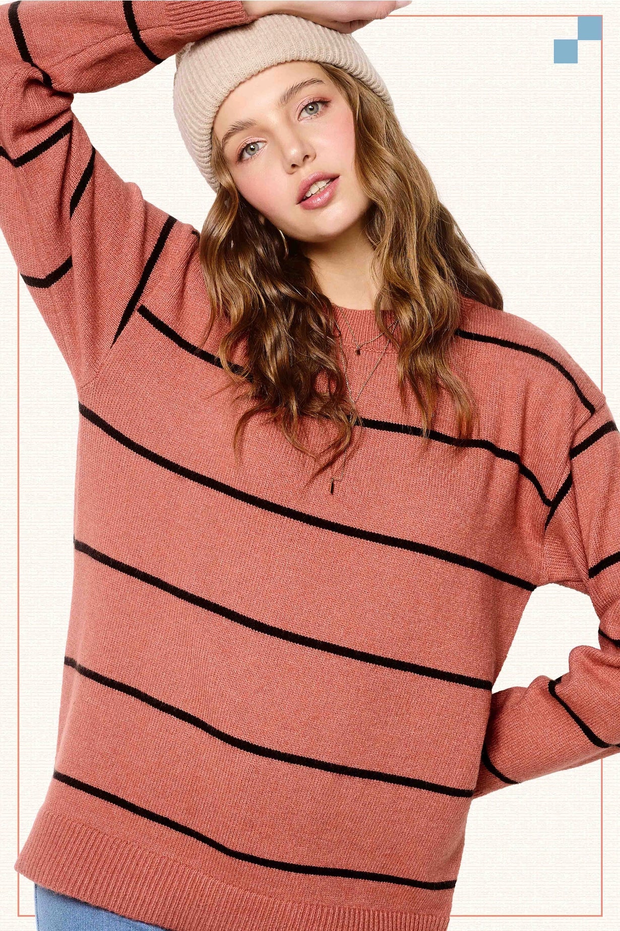 Person wearing a striped sweater and beanie against a plain background, sweaters for women, sweaters near me, stores in Fayetteville ar