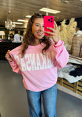 Load image into Gallery viewer, Women wearing a pink Arkansas sweatshirt, taking a selfie in a clothing store Fayetteville ar.
