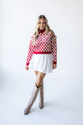 Load image into Gallery viewer, Woman wearing a red and white checkered sweater with 'Arkansas' text, white skirt, and knee-high boots on a white background in a Fayetteville arkansas store
