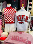Load image into Gallery viewer, Arkansas-themed clothing and accessories on mannequins with 'ARKANSAS ' text in a Fayetteville Arkansas razorback store

