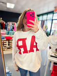 Load image into Gallery viewer, Person wearing a white sweatshirt with red AR letters in Whimsy Whoo Boutique and Shoe Store, Arkansas shirt, arkansans sweatshirt, razorback shirt, Razorback Sweatshirt, clothing stores Fayetteville ar
