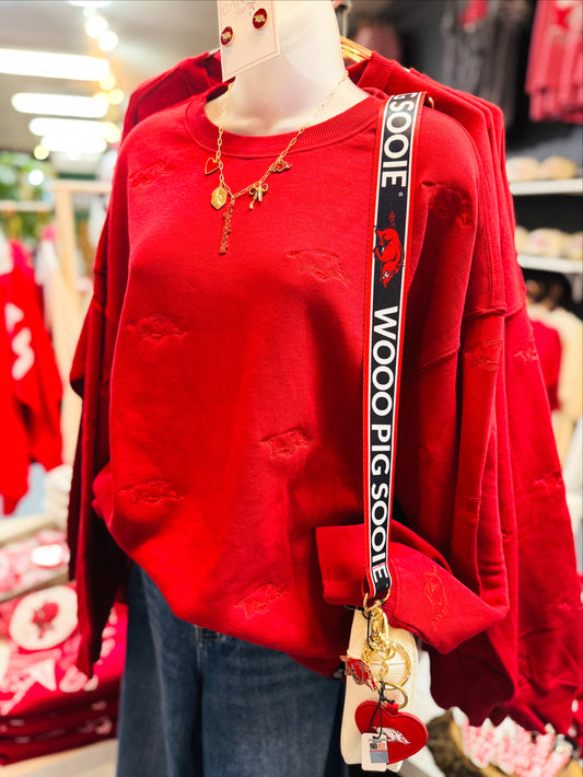 Mannequin wearing a red Arkansas razorback sweatshirt with a 'Woo! Pig Sooie' strap in a Fayetteville, ar store, Arkansas Razorback sweatshirt for women, arkansas razorback store Fayetteville, ar, Arkansas boutique, Whimsy Boutique