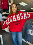 Load image into Gallery viewer, woman in Fayetteville ar razorback store wearing a red oversized razorback sweatshirt with oversize arkansas letters and a hog logo, arkansas sweatshirts, razorback shirt, razorback store near me
