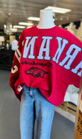 Load image into Gallery viewer, Red arkansas sweatshirt with white arkansas and hogs logo on a mannequin in a Fayetteville ar razorback shoppe, Arkansas sweatshirt, razorback sweatshirts for women, red arkansas razorback sweatshirt
